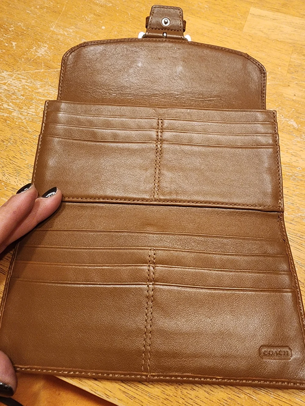 vintage Coach Soho Buckle Wallet crafted in brown leather prominent front Buckle